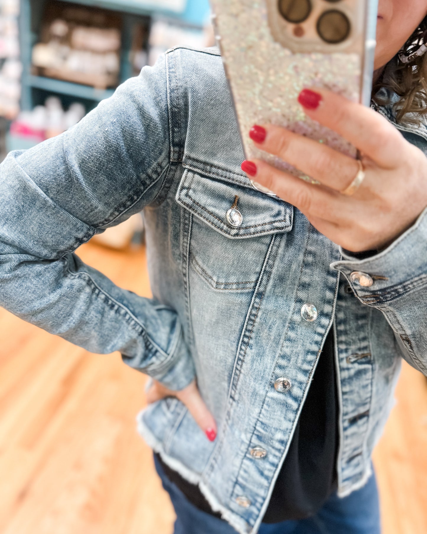 Person wearing a denim jacket with a blurred background