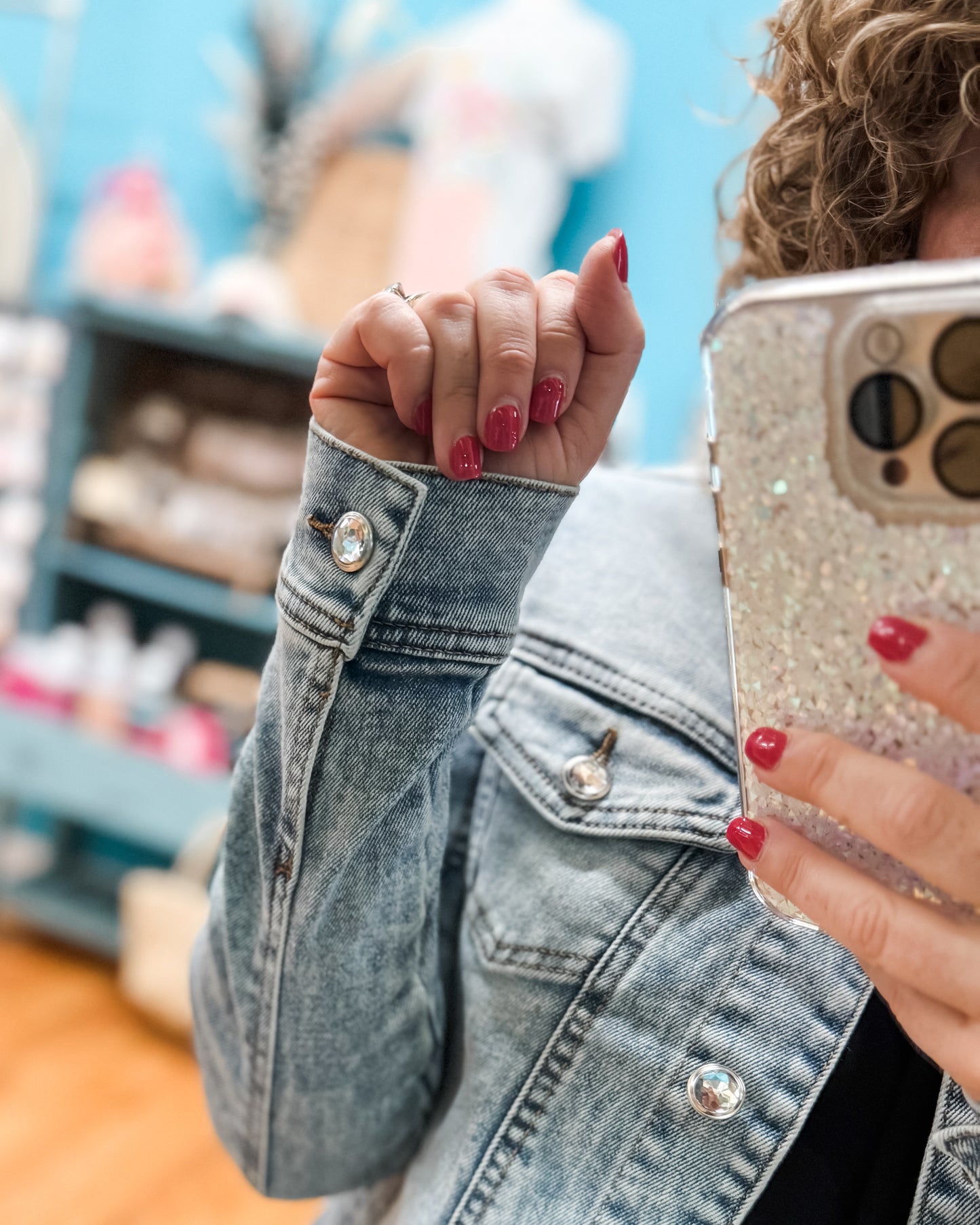 Person wearing a denim jacket with a blurred background