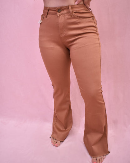Tan pants worn by a person on a pink background