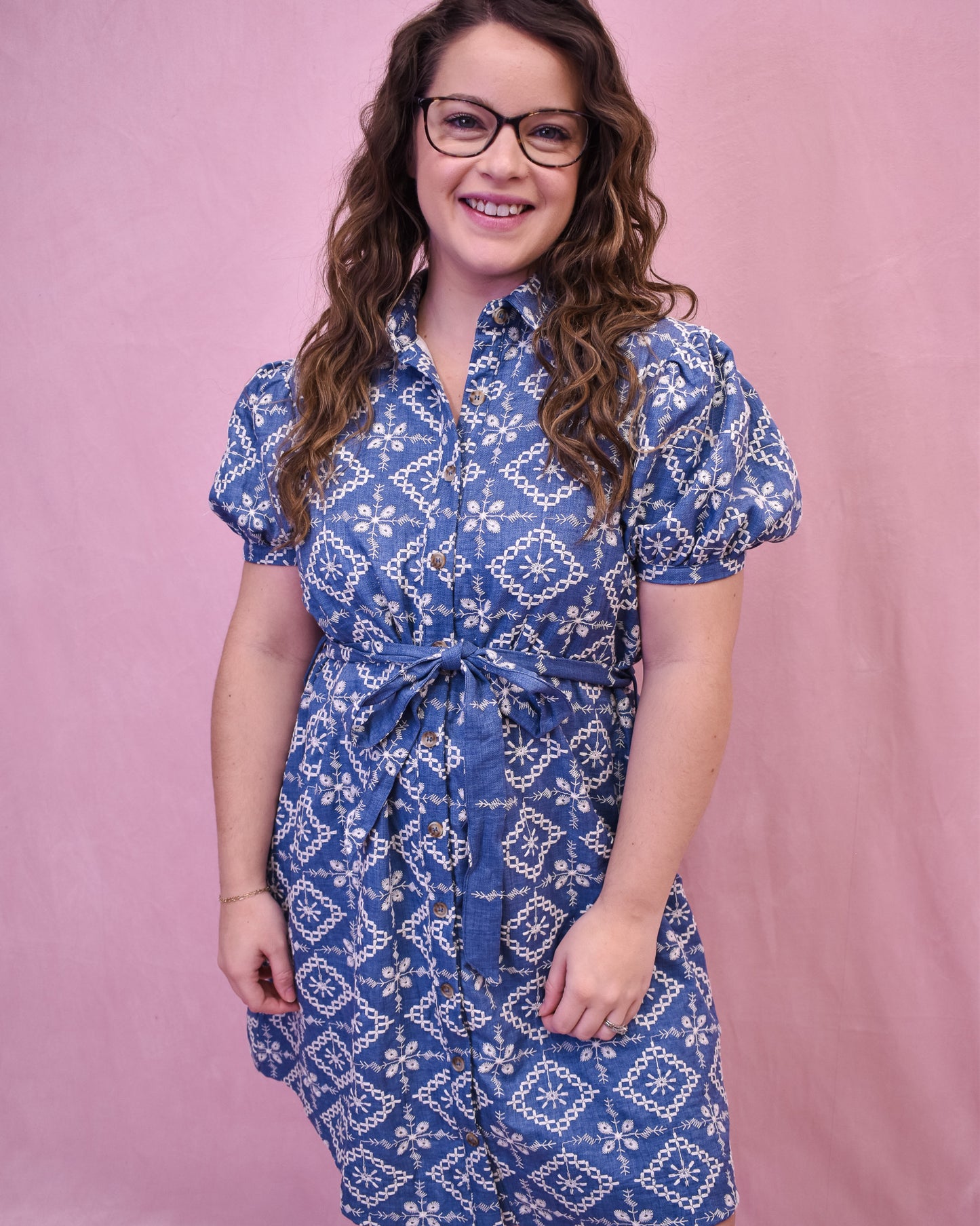 Puff Sleeve Chambray dress with embroidered floral. Button down with a belt tie at the waist.