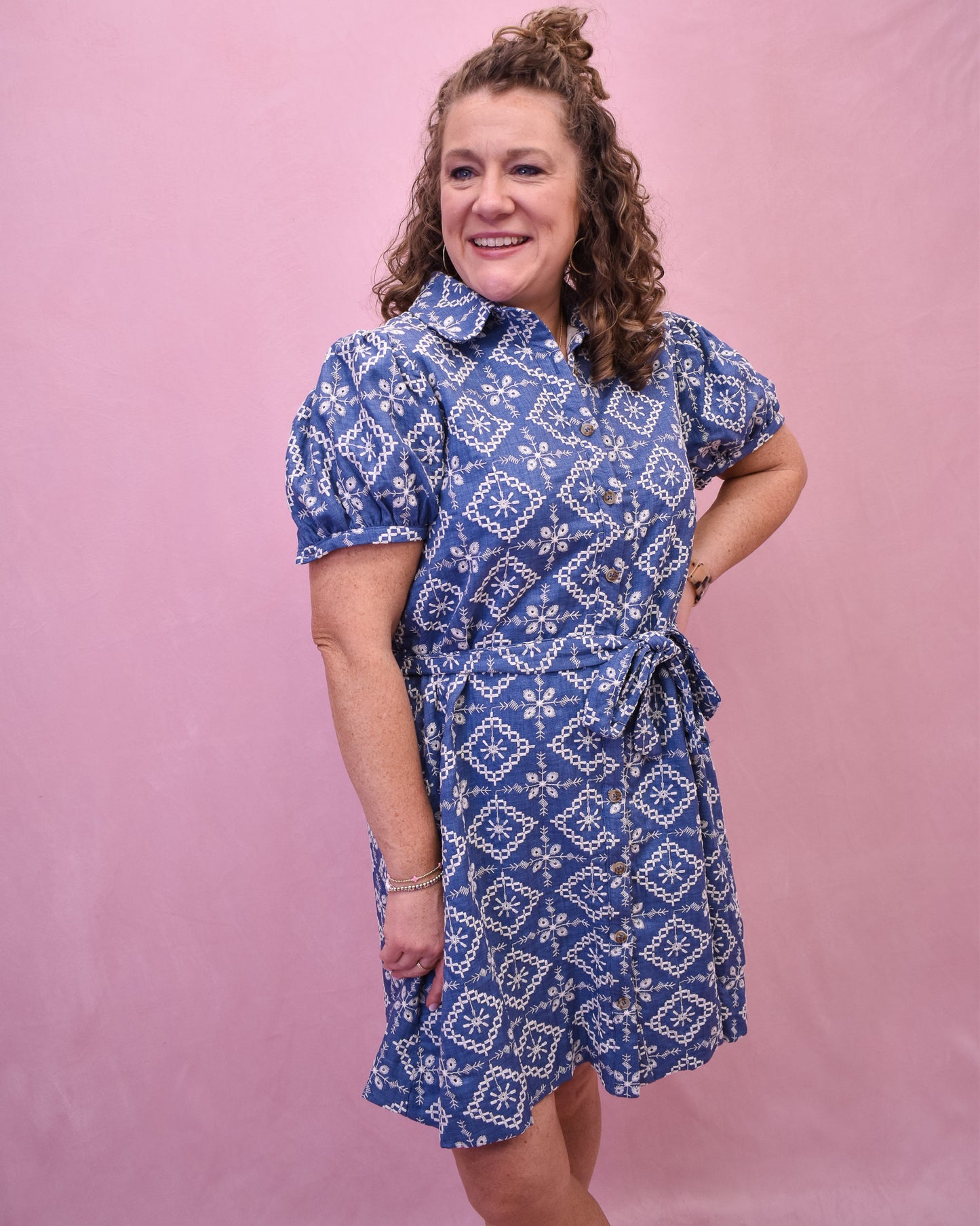 Puff Sleeve Chambray dress with embroidered floral. Button down with a belt tie at the waist.