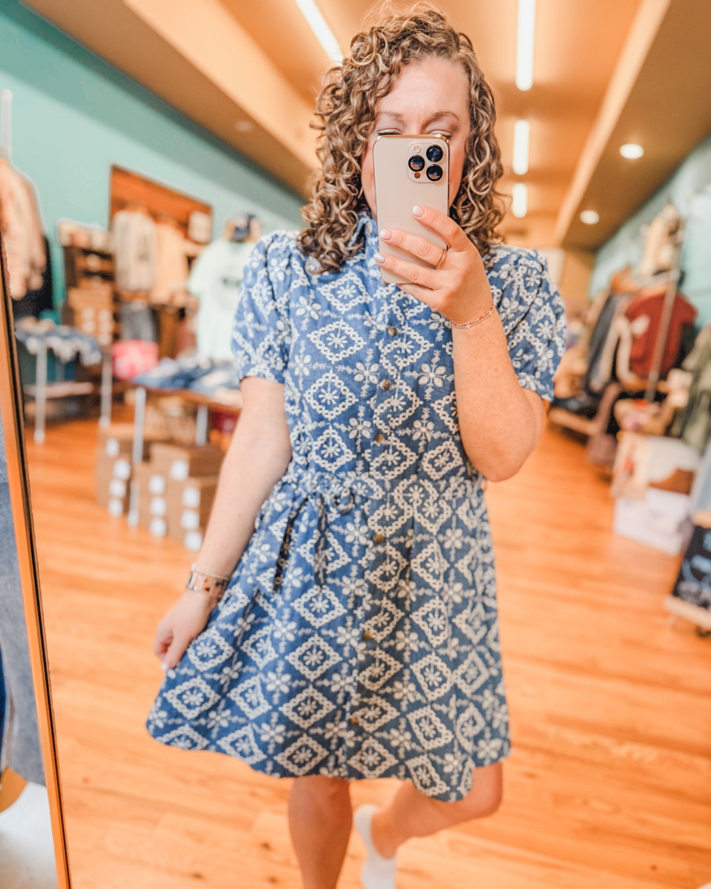 A denim embroidered button down dress with front tie details