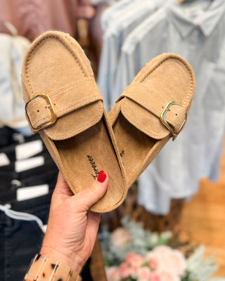 a suede slip on mule style shoe with buckle and side studs