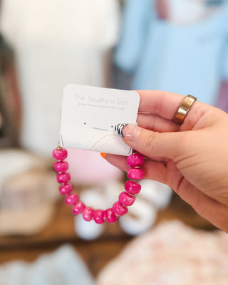 a bright pink chunky beaded bracelet