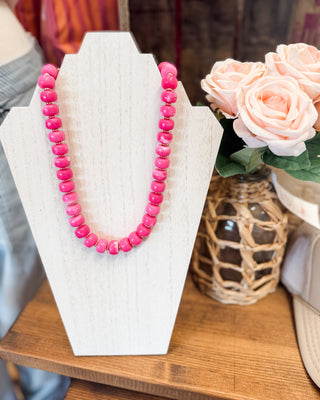 a fuschiacolored beaded necklace