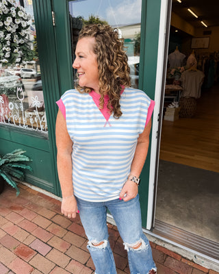 a striped color block top in light blue with pink accents