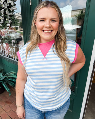 a striped color block top in light blue with pink accents