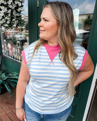 a striped color block top in light blue with pink accents