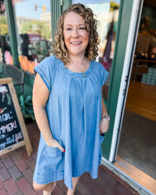 a cap sleeve pleated front denim mini dress with pockets 
