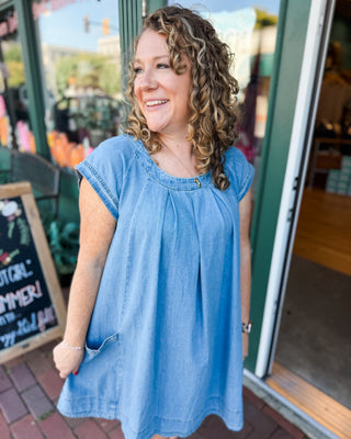 a cap sleeve pleated front denim mini dress with pockets 