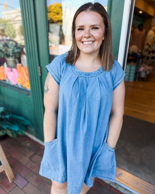 a cap sleeve pleated front denim mini dress with pockets 