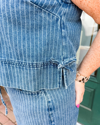 a striped sleeveless denim top with side slits