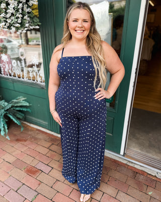 a navy with white polka dot jumpsuit
