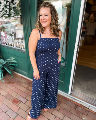 a navy with white polka dot jumpsuit