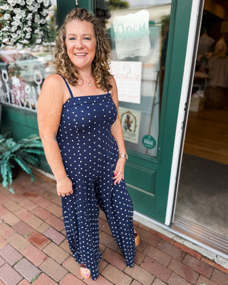 a navy with white polka dot jumpsuit