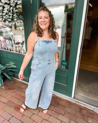 a barrel leg denim jumpsuit with spaghetti straps