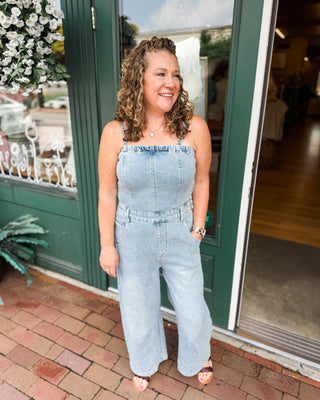 a barrel leg denim jumpsuit with spaghetti straps