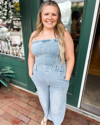 a barrel leg denim jumpsuit with spaghetti straps