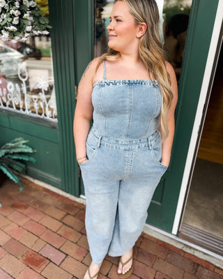 a barrel leg denim jumpsuit with spaghetti straps