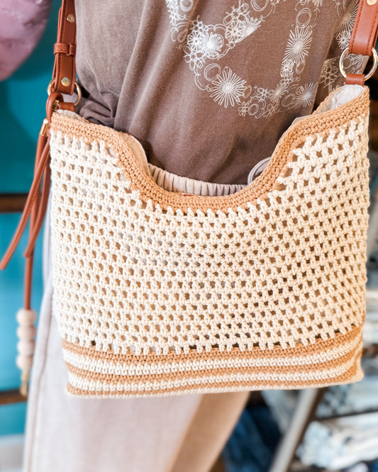 Woven crochet handbag with brown leather straps 