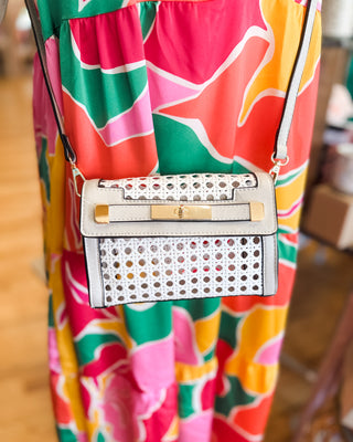 a small rattan crossbody in white with vegan leather details