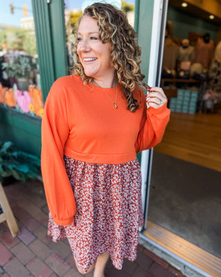 a solid sweatshirt style top with flowy skirt mini dress with floral pattern
