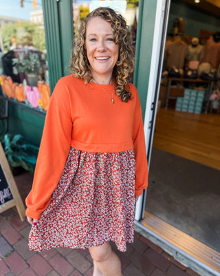 a solid sweatshirt style top with flowy skirt mini dress with floral pattern