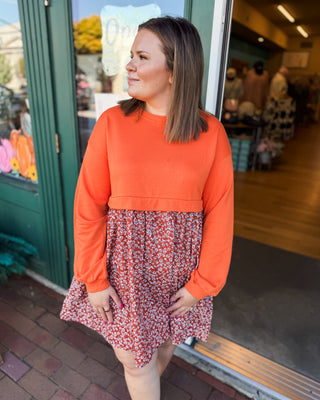 a solid sweatshirt style top with flowy skirt mini dress with floral pattern