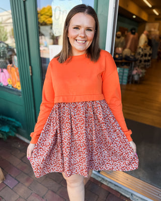 a solid sweatshirt style top with flowy skirt mini dress with floral pattern