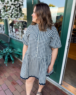 a short sleeve drop hem navy gingham dress with button down front and ric rac hem details