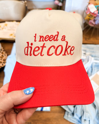 a red canvas hat that says i need a diet coke