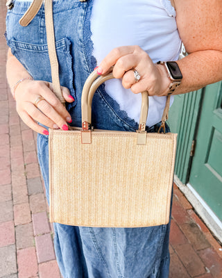 A Tan Rattan Style Bag with dual handles and crossbody strap
