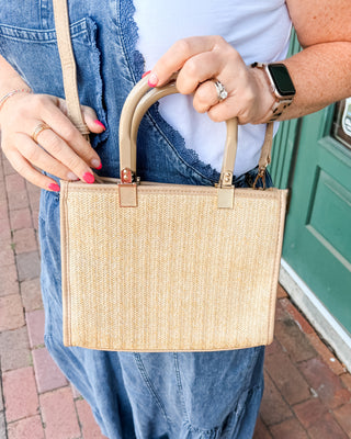 A Tan Rattan Style Bag with dual handles and crossbody strap