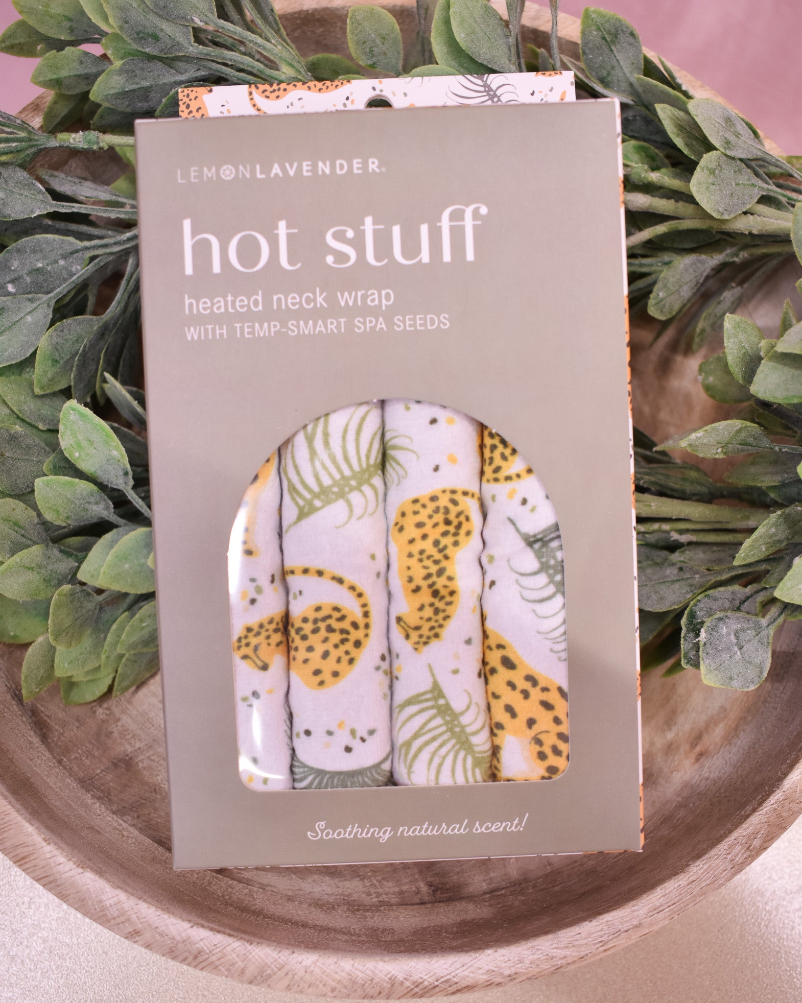 Hot stuff heated neck wrap packaging with floral design on a green leafy background