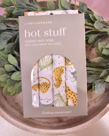 Hot stuff heated neck wrap packaging with floral design on a green leafy background