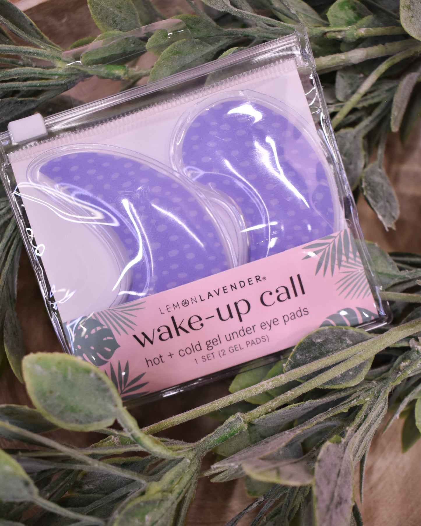 Pack of 'wake-up call' gel under eye pads with a pink label on green leaves.
