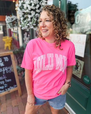 A graphic tee in neon pink with LULU MAC graphic in light pink and polka dots