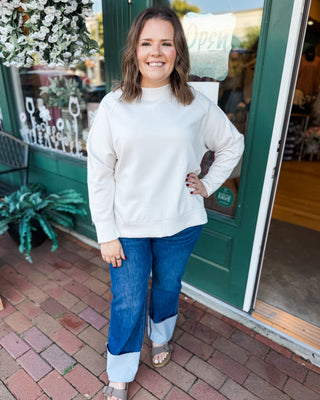 a long sleeve pullover in scuba soft material with a side slit
