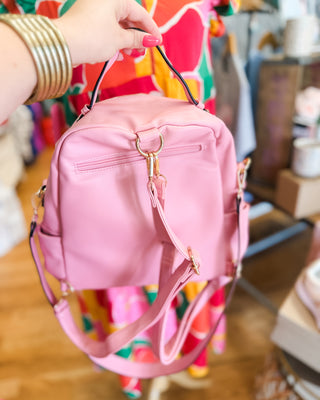a trendy pink convertible crossbody backpack purse