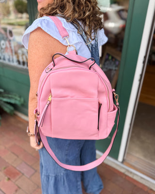 a trendy vegan leather pink convertible backpack purse