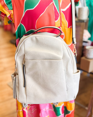 a trendy white convertible crossbody backpack purse