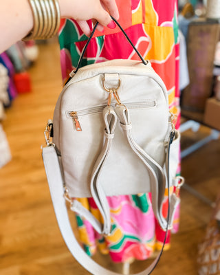 a trendy white convertible crossbody backpack purse