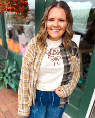 Perfectly Undone Mixed Print Plaid Distressed Top A long sleeve button down mixed print plaid top.