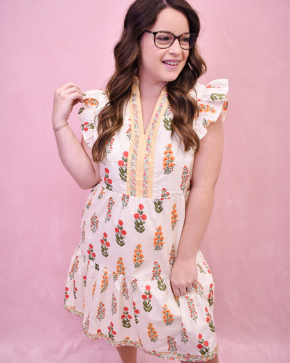 Cream colored floral mini dress with flutter sleeves