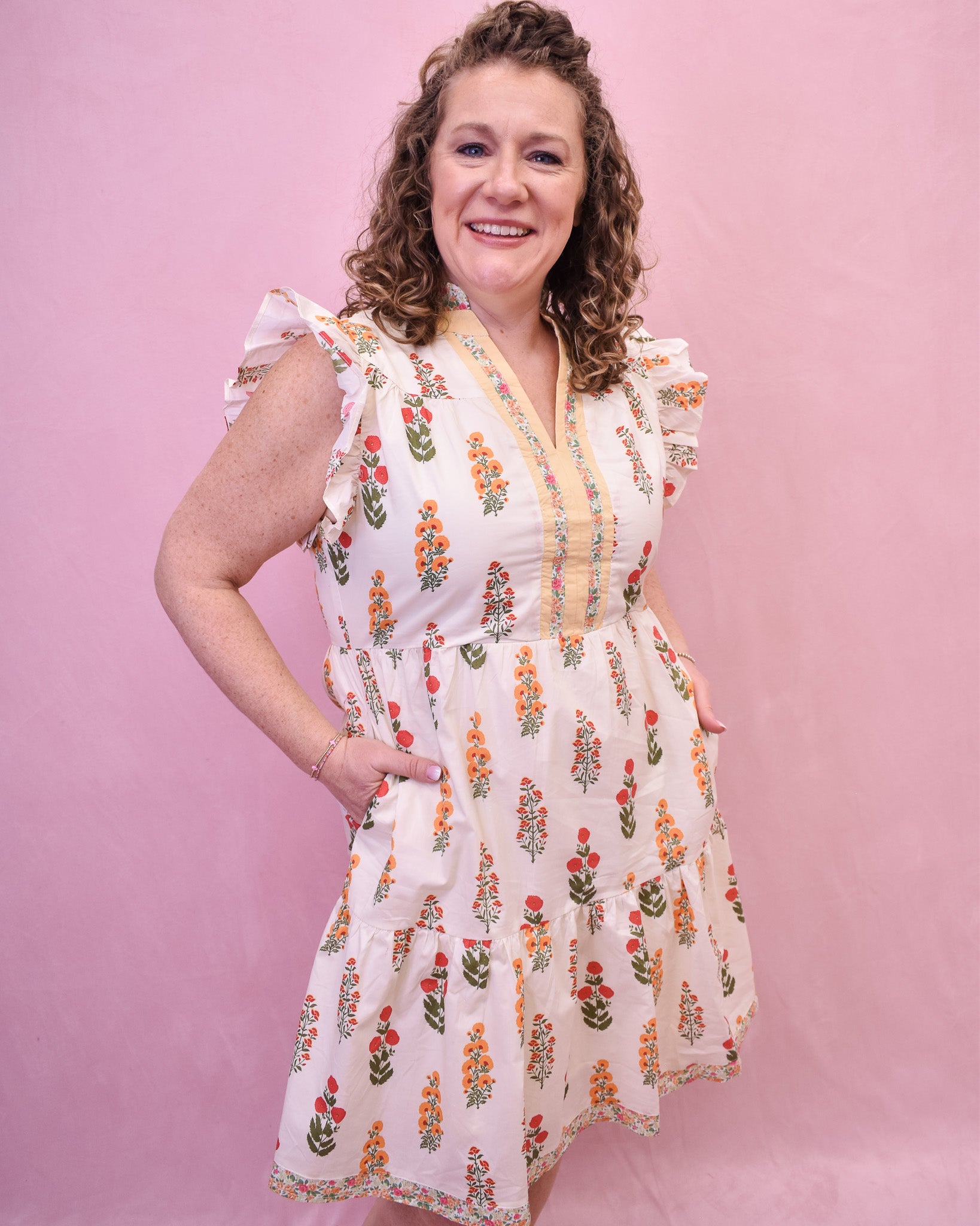 Cream colored floral mini dress with flutter sleeves