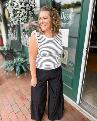 Flowy wide leg pull-on pants featuring feminine tiered ruffle details and lightweight polyester fabric. The perfect statement pants for vacations, brunch, special occasions, and effortless everyday style.