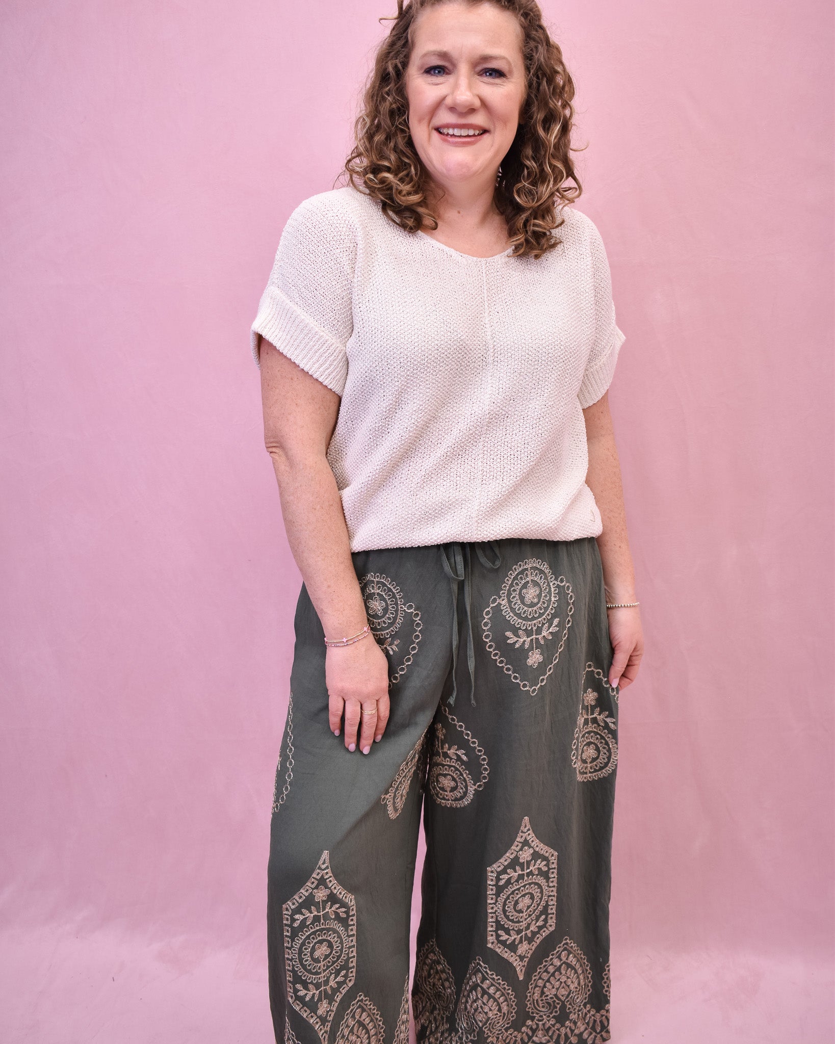 Cream top with geometric wide leg pants in an olive color