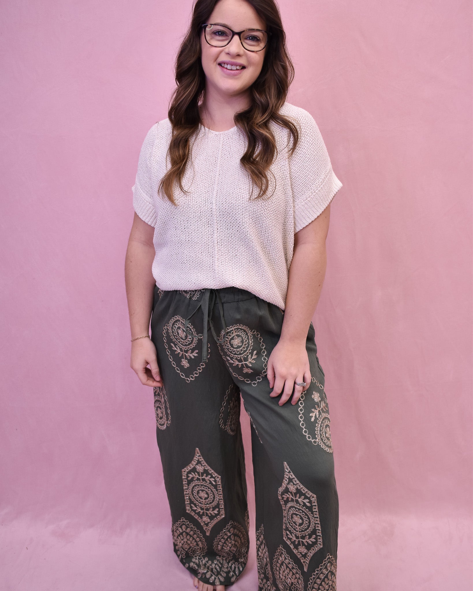 cream top with olive colored wide leg pants with geometric pattern