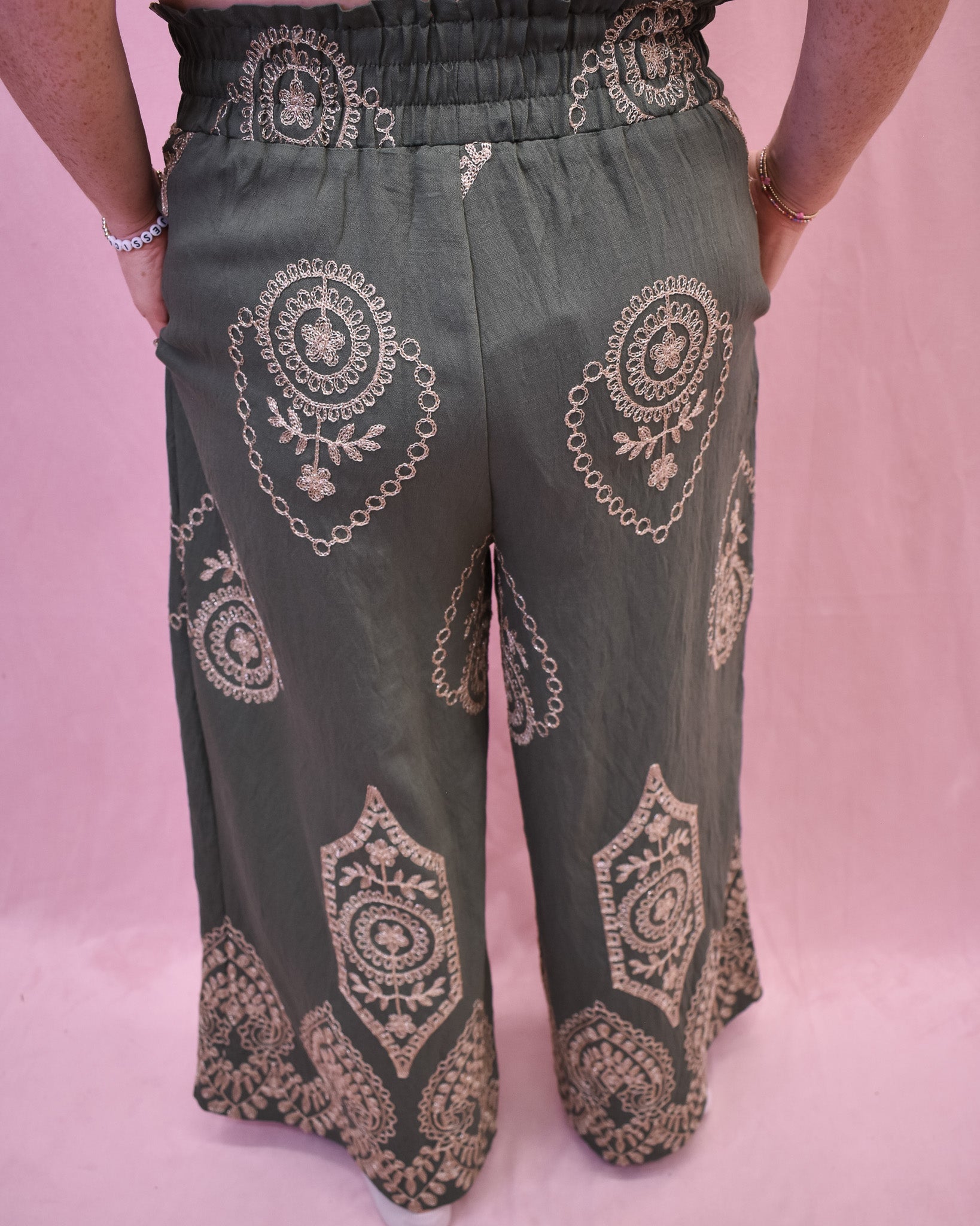 Green wide leg pants with intricate gold embroidered details 