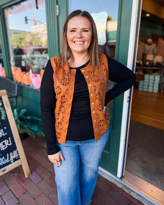 a sleeveless suede laser cutout button down vest in a cognac color.